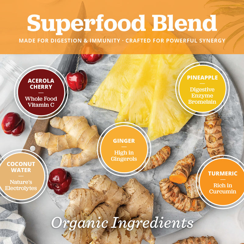 Superfood blend ingredients including pineapple, ginger, turmeric, coconut water and acerola cherry on a marble surface.